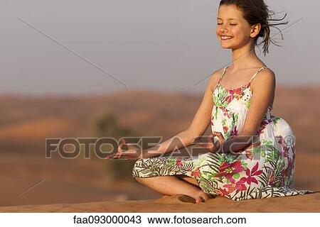 Girl meditating in desert View Large Photo Image Stock Image - Girl meditating in desert. Fotosearch