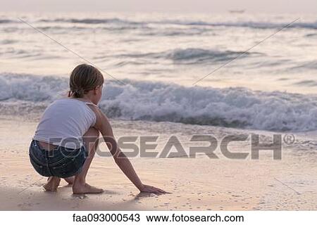 Girl playing with water on beach, rear view View Large Photo Image Stock Image - Girl playing with water on beach, rear view. Fotosearch