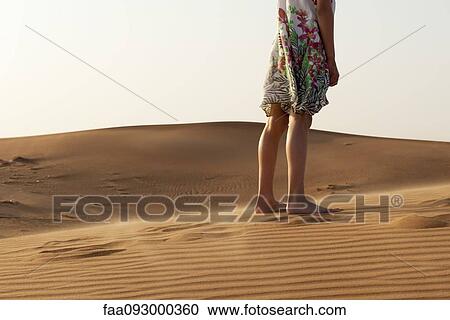 Girl standing barefoot in desert, cropped View Large Photo Image Stock Image - Girl standing barefoot in desert, cropped. Fotosearch