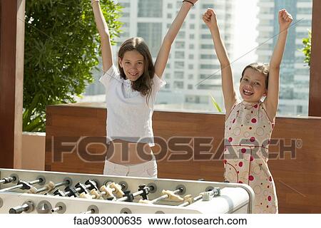 Stock Photography - Girls winning at foosball. Fotosearch