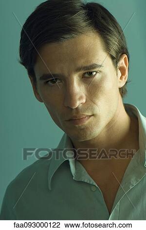 Stock Image - Handsome man looking seductively at camera, portrait. Fotosearch