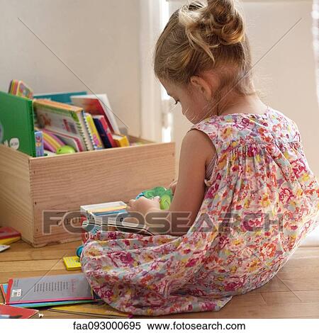 Little girl sitting on floor reading books View Large Photo Image Stock Photography - Little girl sitting on floor reading books. Fotosearch