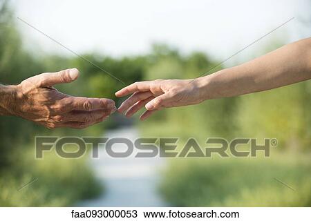 Man and woman reaching out to shake hands View Large Photo Image Stock Image - Man and woman reaching out to shake hands. Fotosearch