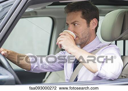 Man drinking coffee whlile driving View Large Photo Image Stock Image - Man drinking coffee whlile driving. Fotosearch