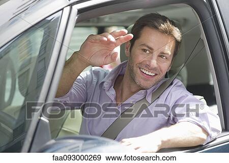 Man driving car, smiling out window and waving View Large Photo Image Stock Photo - Man driving car, smiling out window and waving. Fotosearch