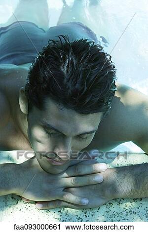 Man in water, resting head on arms on side of pool View Large Photo Image Stock Image - Man in water, resting head on arms on side of pool. Fotosearch