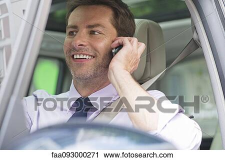 Man talking on cell phone while driving View Large Photo Image Stock Image - Man talking on cell phone while driving. Fotosearch