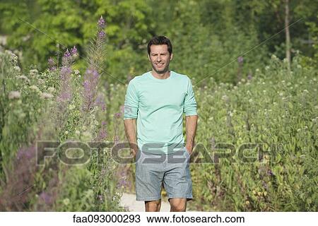 Stock Image - Mature man enjoying time outdoors, portrait. Fotosearch