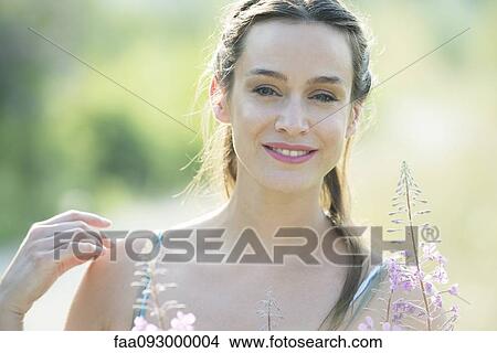 Picture - Mid-adult woman outdoors, portrait. Fotosearch