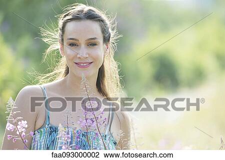 Mid-adult woman outdoors, portrait View Large Photo Image Stock Image - Mid-adult woman outdoors, portrait. Fotosearch