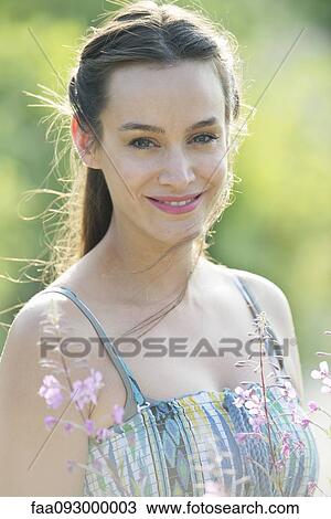 Mid-adult woman outdoors, portrait View Large Photo Image Stock Image - Mid-adult woman outdoors, portrait. Fotosearch