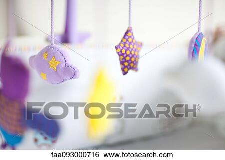 Stock Photograph - Mobile hanging in nursery, close-up. Fotosearch