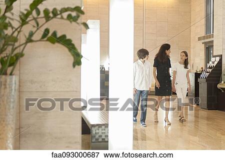 Mother and children walking in hotel lobby View Large Photo Image Stock Photo - Mother and children walking in hotel lobby. Fotosearch