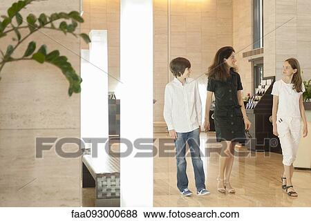 Mother and children walking in hotel lobby View Large Photo Image Stock Photo - Mother and children walking in hotel lobby. Fotosearch