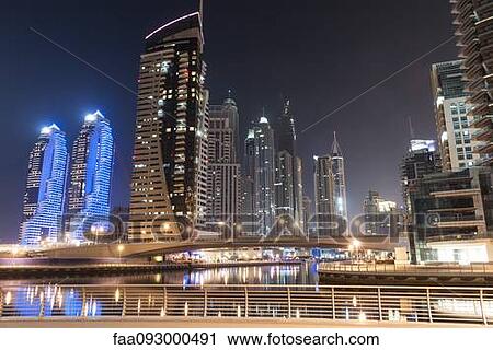 Skyscrapers illuminating marina by night View Large Photo Image Stock Image - Skyscrapers illuminating marina by night. Fotosearch