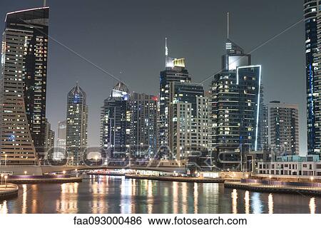 Skyscrapers illuminating marina by night View Large Photo Image Stock Photograph - Skyscrapers illuminating marina by night. Fotosearch