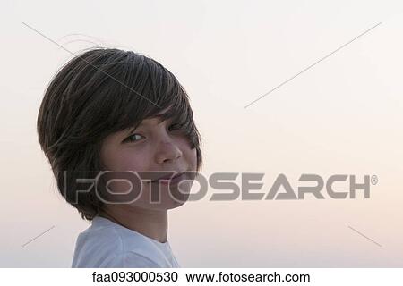 Teenage boy looking over shoulder, portrait View Large Photo Image Stock Image - Teenage boy looking over shoulder, portrait. Fotosearch