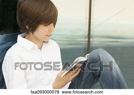 Teenage boy reading book View Large Photo Image Stock Photo - Teenage boy reading book. Fotosearch