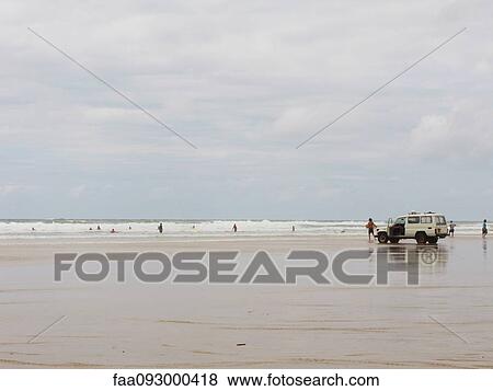 Vacationers exiting SUV parked on beach View Large Photo Image Stock Photo - Vacationers exiting SUV parked on beach. Fotosearch