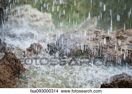 Picture - Water splashing on rocks. Fotosearch