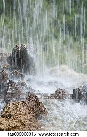 Stock Photography - Waterfall splashing on rocks. Fotosearch