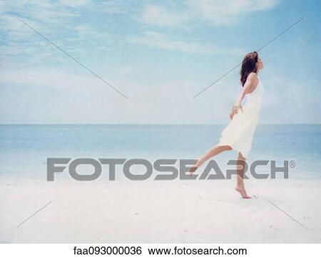 Woman at beach, balancing on one leg View Large Photo Image Stock Photograph - Woman at beach, balancing on one leg. Fotosearch