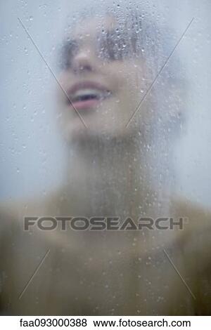 Woman behind wet glass, head back, close-up View Large Photo Image Stock Photo - Woman behind wet glass, head back, close-up. Fotosearch