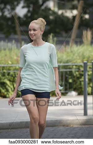 Stock Image - Woman crossing street. Fotosearch
