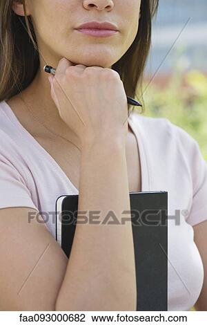 Woman holding diary, cropped View Large Photo Image Stock Image - Woman holding diary, cropped. Fotosearch