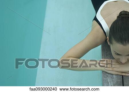 Woman in bathing suit lying on deck next to pool View Large Photo Image Stock Image - Woman in bathing suit lying on deck next to pool. Fotosearch
