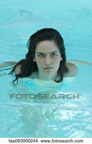 Picture - Woman in swimming pool, looking at camera. Fotosearch