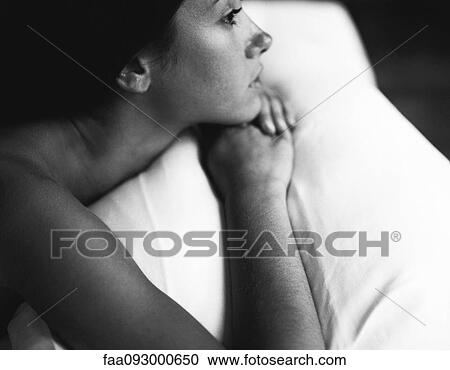 Stock Image - Woman lying down, black and white. Fotosearch
