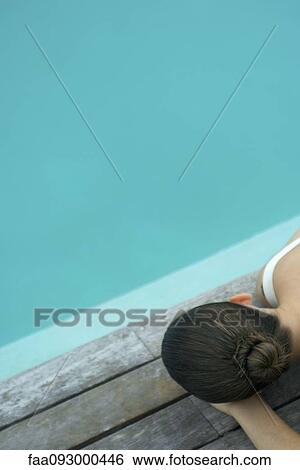 Woman lying on deck next to pool View Large Photo Image Stock Photograph - Woman lying on deck next to pool. Fotosearch