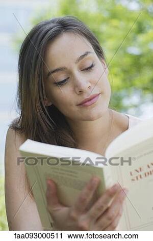 Woman reading book outdoors View Large Photo Image Stock Image - Woman reading book outdoors. Fotosearch