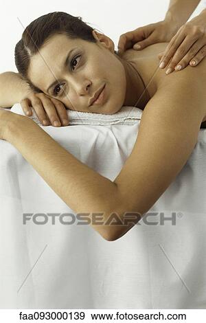 Stock Photo - Woman receiving back massage, smiling, close-up. Fotosearch