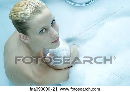 Woman sitting in bubble bath, looking at camera, high angle view View Large Photo Image Stock Image - Woman sitting in bubble bath, looking at camera, high angle view. Fotosearch