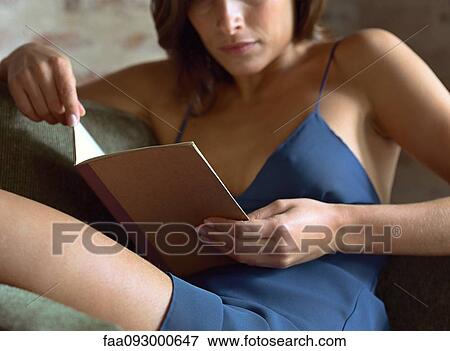 Woman sitting in chair, reading View Large Photo Image Stock Photo - Woman sitting in chair, reading. Fotosearch