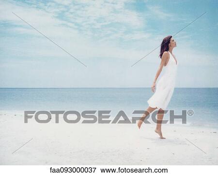 Woman standing on one leg on beach, side view View Large Photo Image Stock Photo - Woman standing on one leg on beach, side view. Fotosearch