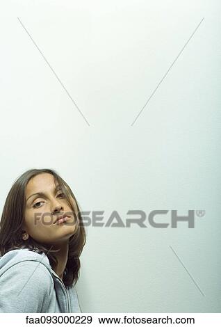 Stock Photo - Woman wearing hooded sweatshirt, portrait. Fotosearch