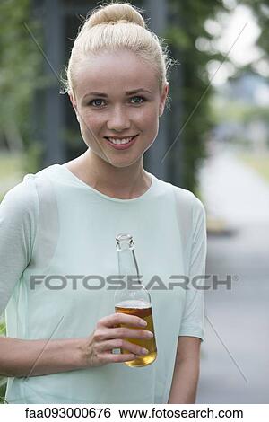 Woman with beer at social gathering View Large Photo Image Stock Photograph - Woman with beer at social gathering. Fotosearch