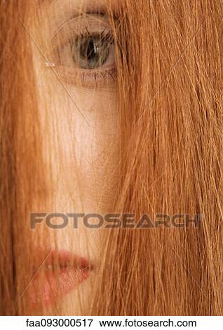 Woman with hair in front of face, close-up View Large Photo Image Stock Photo - Woman with hair in front of face, close-up. Fotosearch