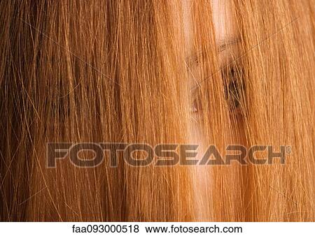 Woman with hair in front of face, close-up View Large Photo Image Stock Photo - Woman with hair in front of face, close-up. Fotosearch
