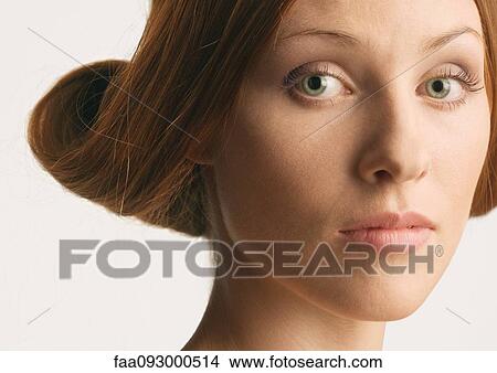 Woman with rolled up hairstyle View Large Photo Image Picture - Woman with rolled up hairstyle. Fotosearch
