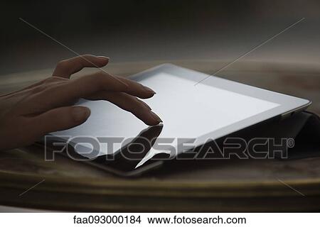 Woman's hand using digital tablet View Large Photo Image Picture - Woman's hand using digital tablet. Fotosearch