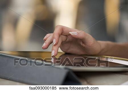 Woman's hand using digital tablet View Large Photo Image Stock Photography - Woman's hand using digital tablet. Fotosearch