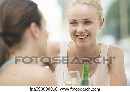 Women chatting and having drinks View Large Photo Image Stock Photograph - Women chatting and having drinks. Fotosearch