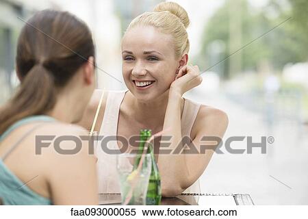 Women chatting at sidewalk cafe View Large Photo Image Stock Photography - Women chatting at sidewalk cafe. Fotosearch