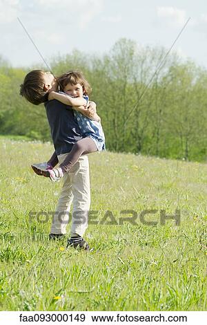 Young siblings embracing outdoors View Large Photo Image Stock Photo - Young siblings embracing outdoors. Fotosearch