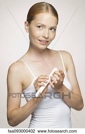 Young woman daydreaming while filing fingernails View Large Photo Image Stock Image - Young woman daydreaming while filing fingernails. Fotosearch