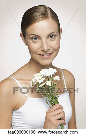 Young woman enjoying fragrence of bouquet of daisies View Large Photo Image Stock Image - Young woman enjoying fragrence of bouquet of daisies. Fotosearch